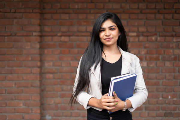 female student standing with books