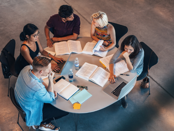 Group of students studiyng together at a table.